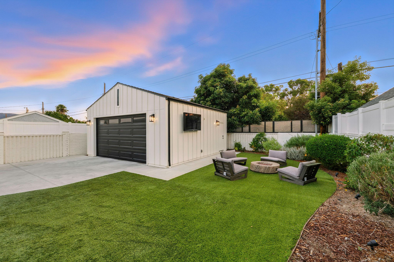 Modern Backyard With Garage And Patio Furniture